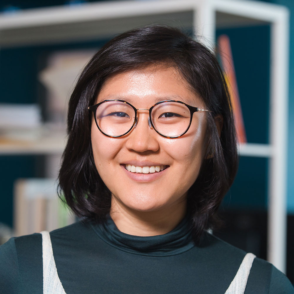 Headshot of Seongkyul Park smiling in front of a bookshelf.