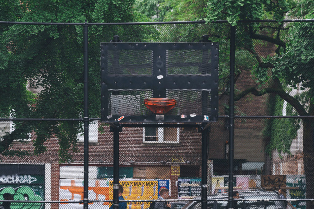 A basketball hoop in a city park.