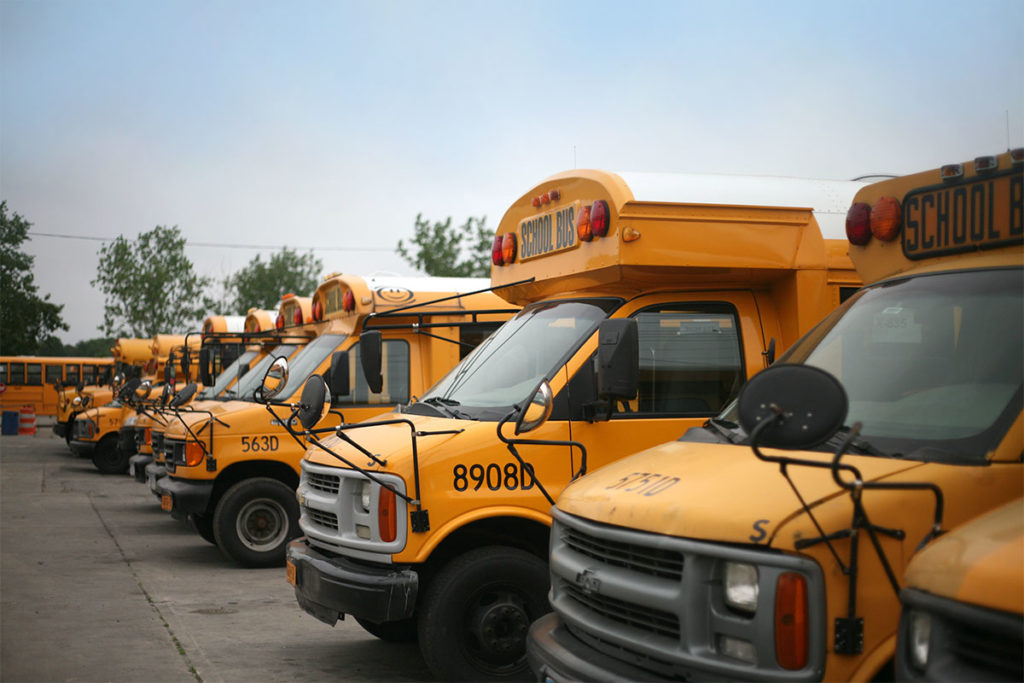 A line of parked school buses.