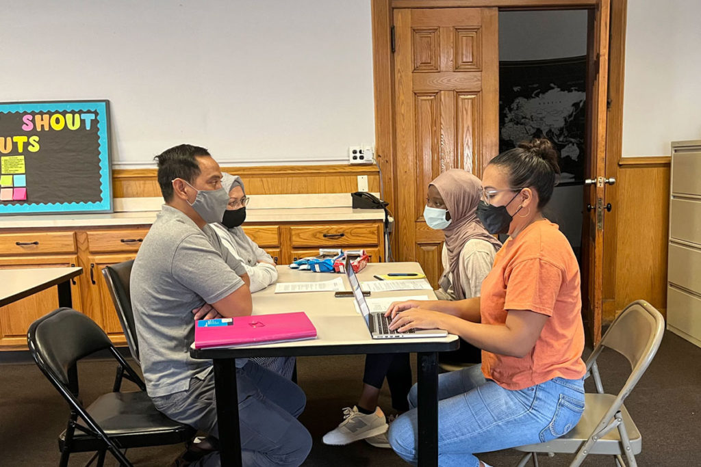 Public Policy Lab team members sit in conversation with collaborators at a table.